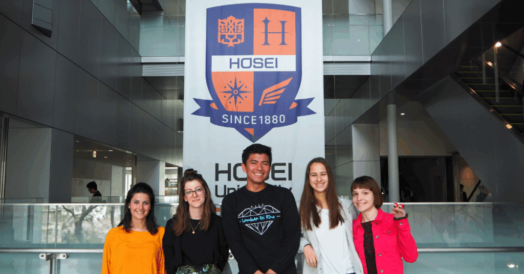 group of students at Hosei University in front of Hosei banner