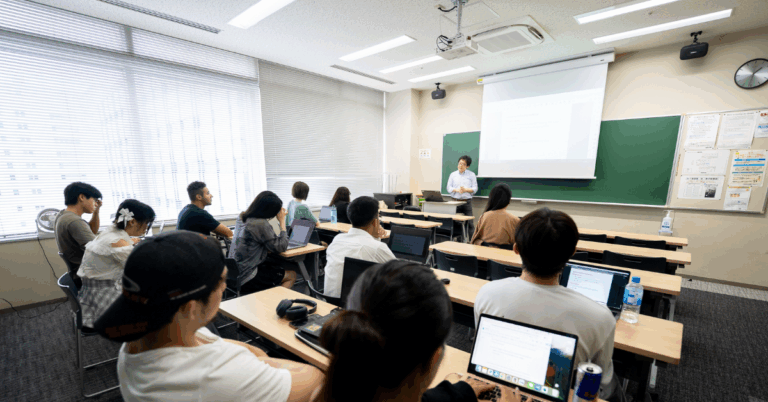 students in university classroom listening as professor lectures them