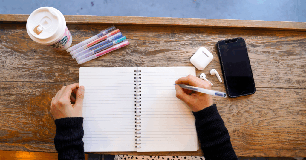 flat lay of notebook, pens, coffee