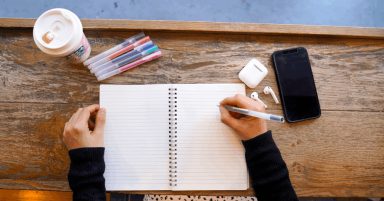 flat lay of notebook, pens, coffee