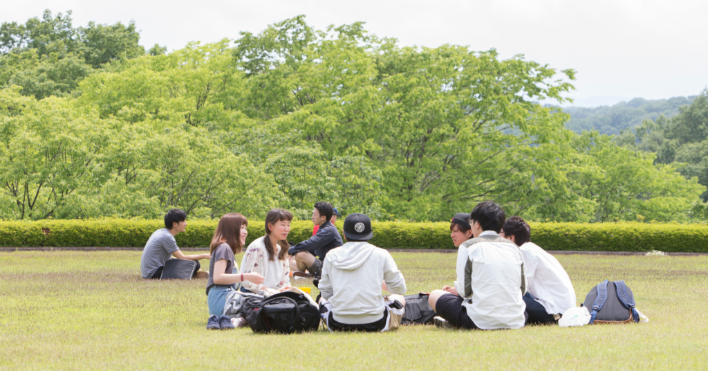students on a lawn at hosei university